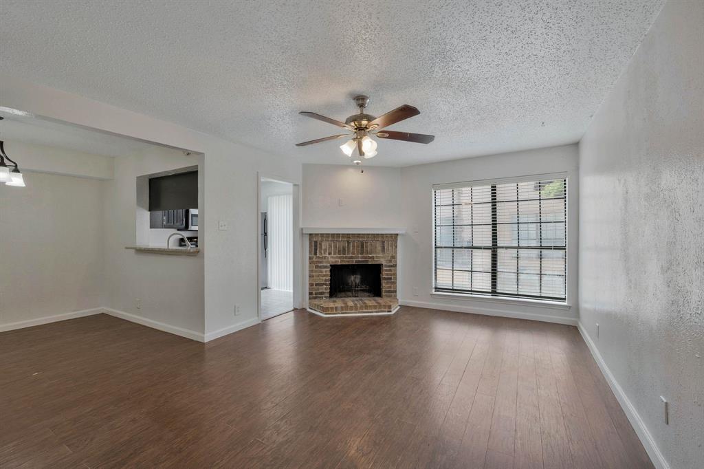 an empty room with windows and a fireplace