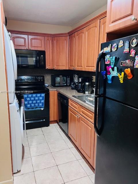 a kitchen with stainless steel appliances a stove a microwave and a sink