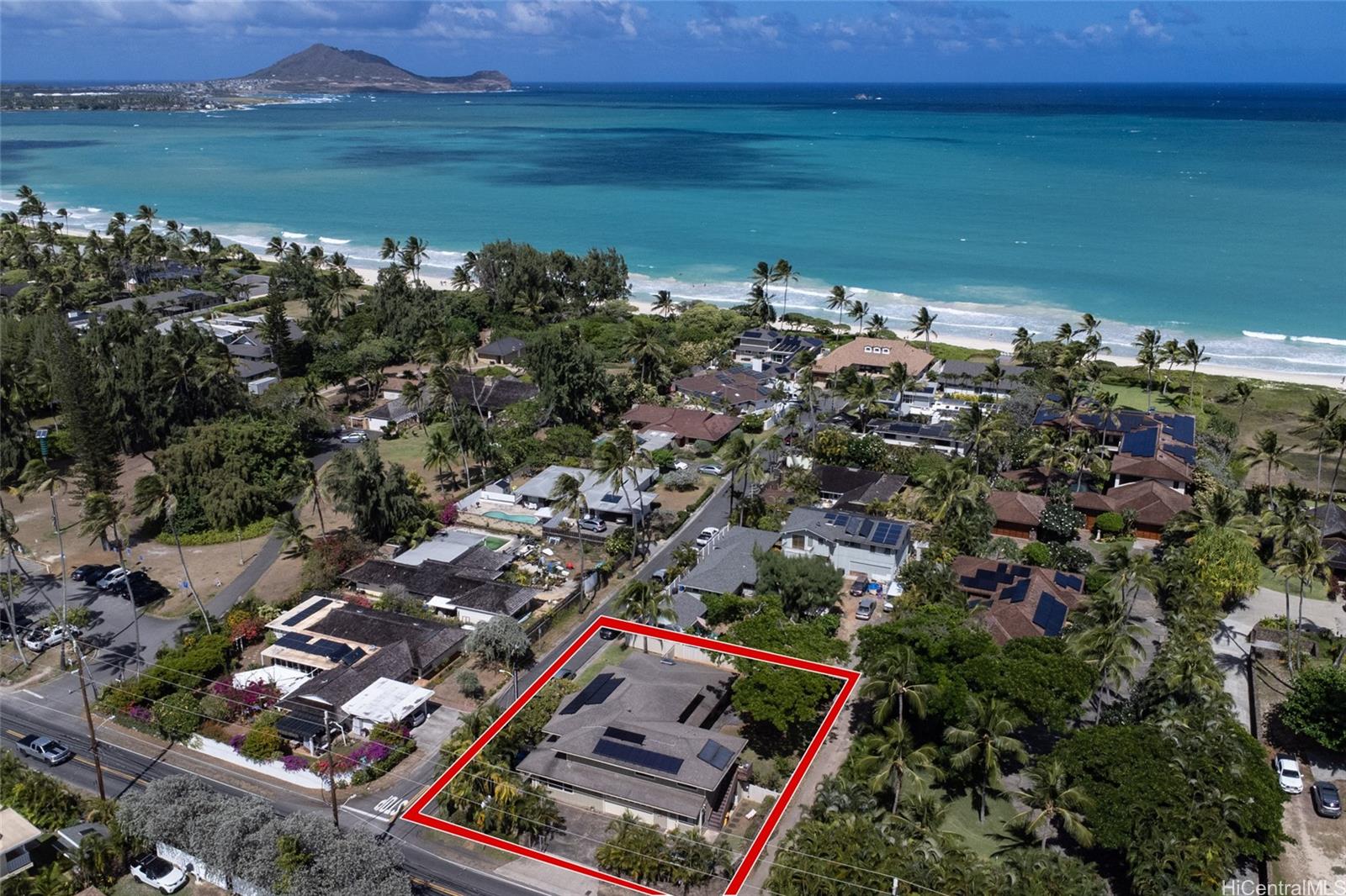 an aerial view of a city with lots of residential buildings lake and ocean view