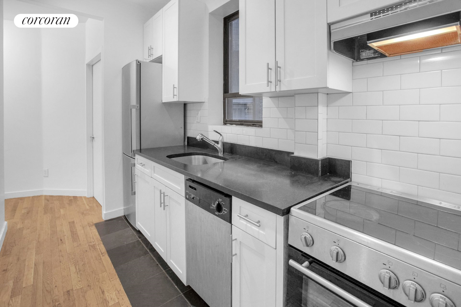 a kitchen with stainless steel appliances granite countertop a sink and a refrigerator