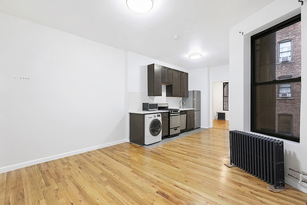 a kitchen with stainless steel appliances a refrigerator and a stove top oven