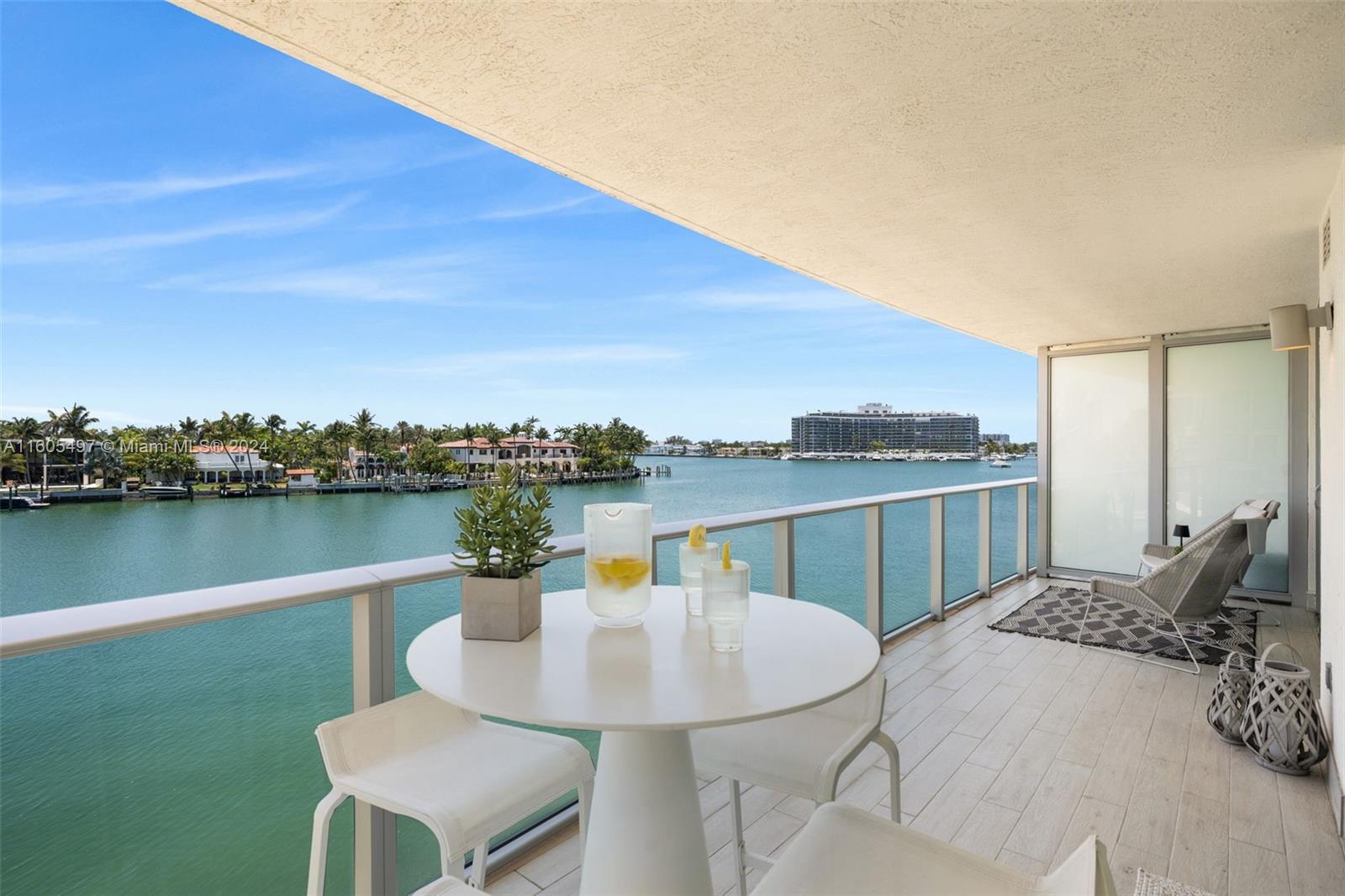 a view of a lake with a table and chairs