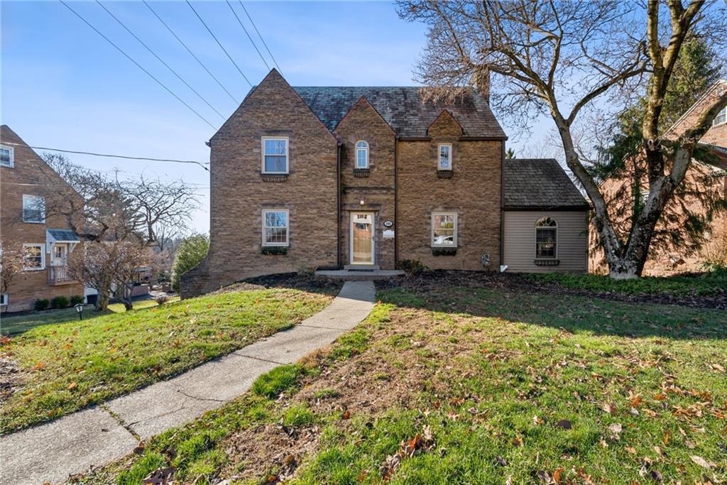 a front view of a house with a yard