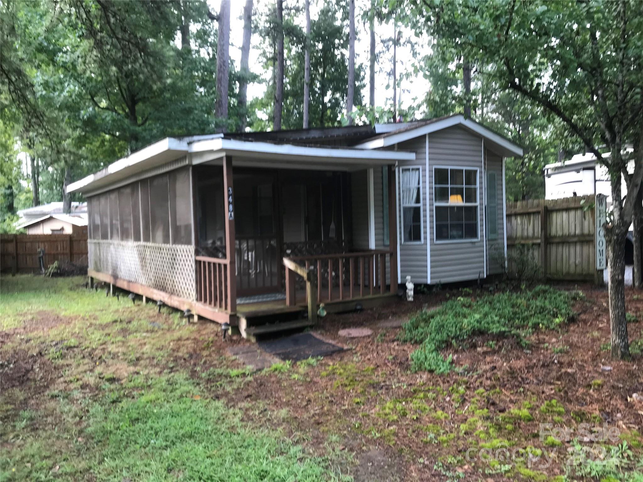 a view of a small house with a yard