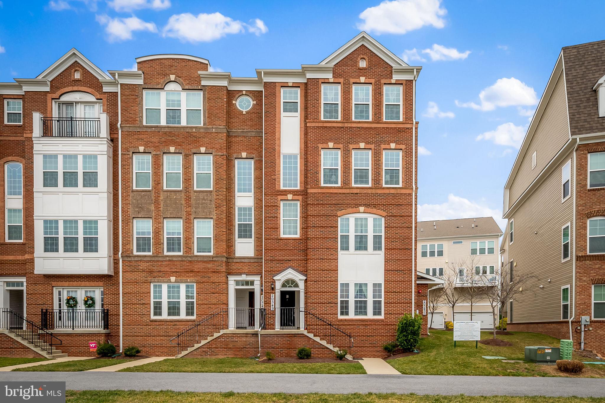 a front view of a residential apartment building with a yard