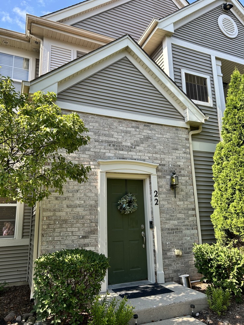 a front view of a house with plants