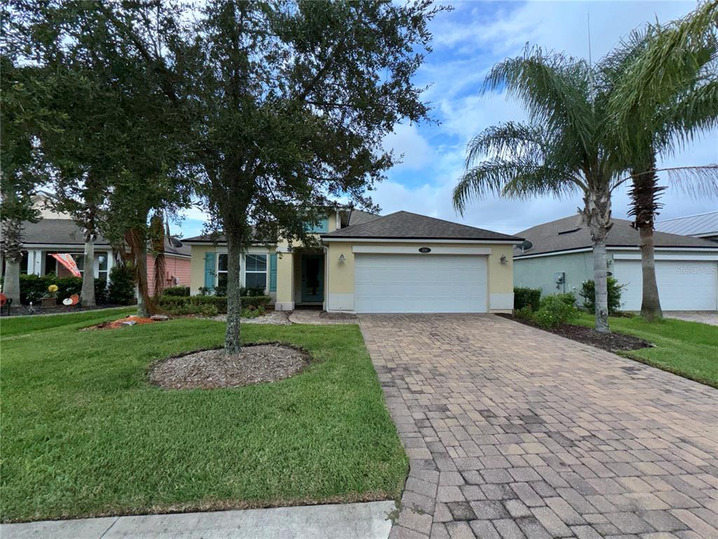 a front view of a house with a yard and garage