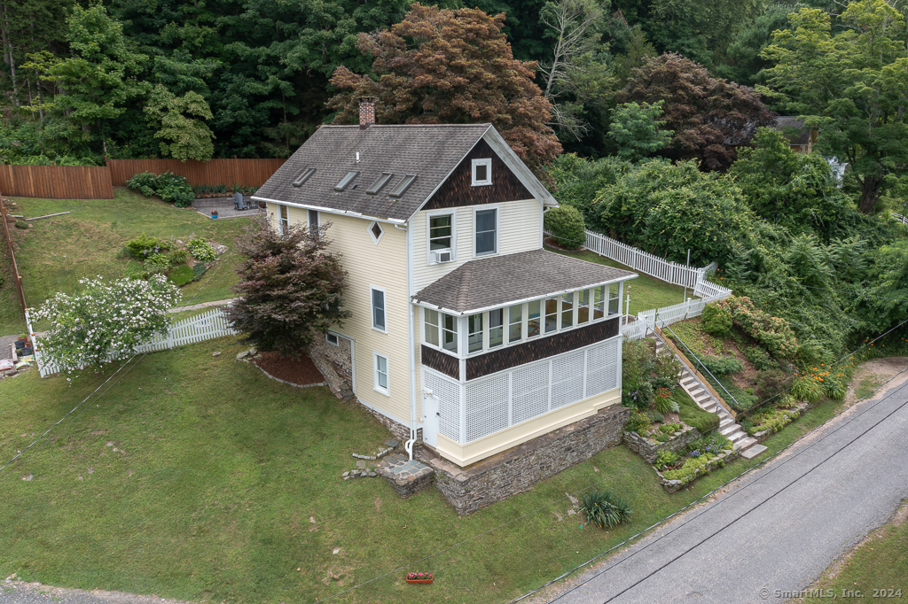 a aerial view of a house in a yard with potted plants