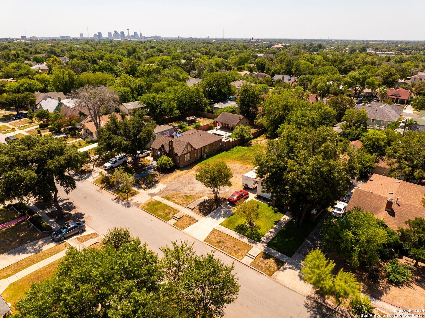 an aerial view of residential houses with outdoor space