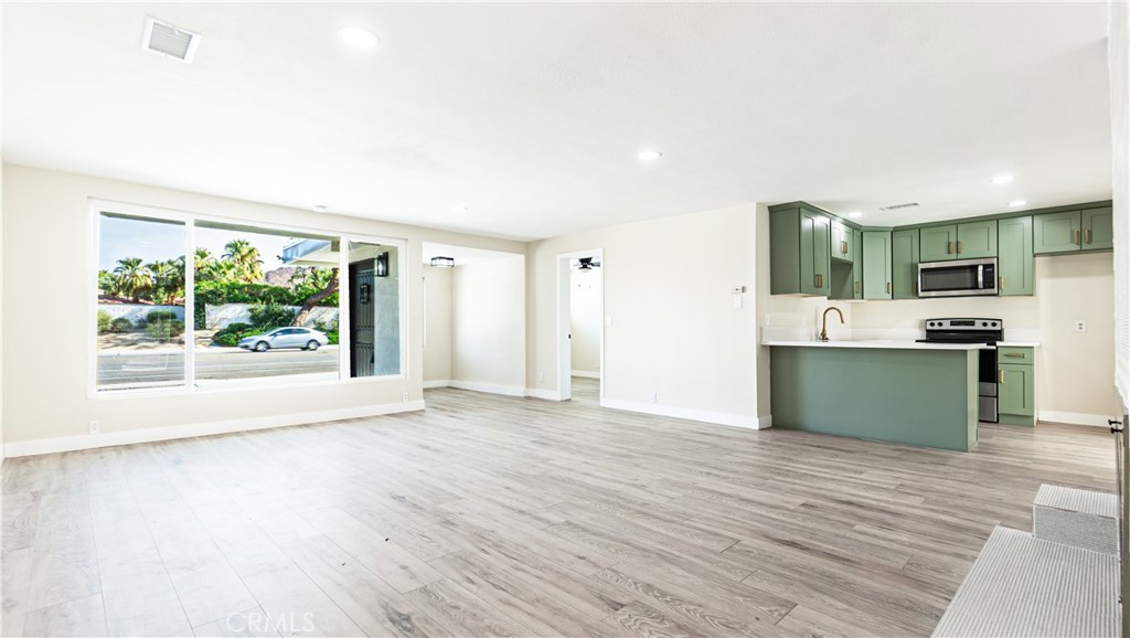 a view of kitchen with window and wooden floor