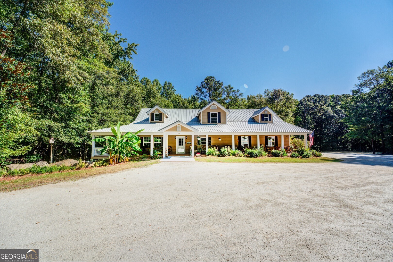 a front view of a house with a garden