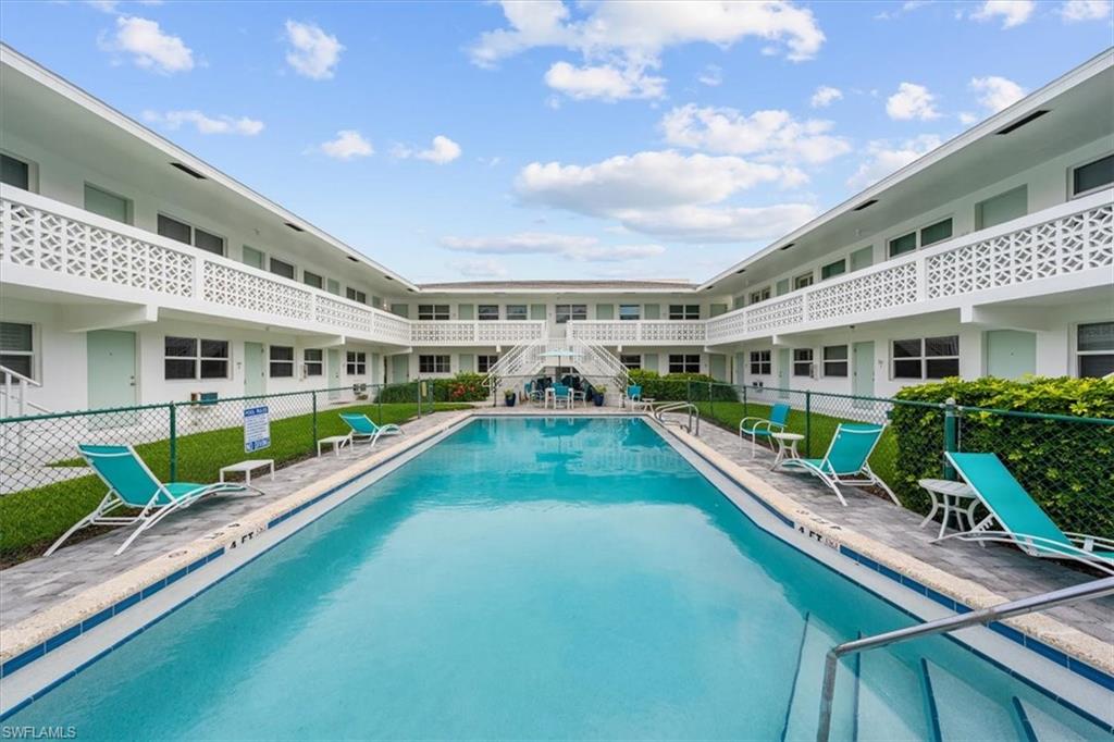 a view of house with swimming pool outdoor seating