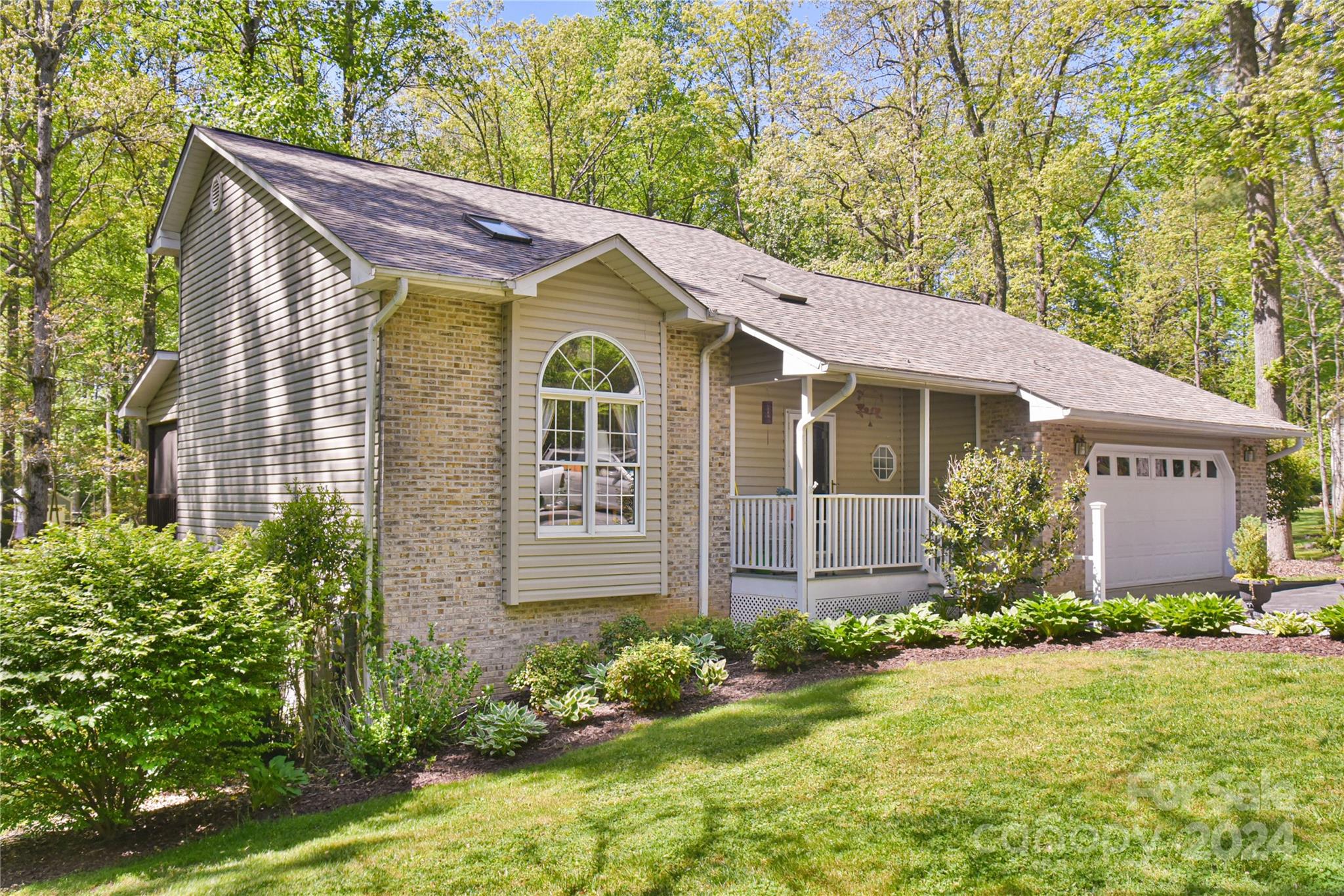 a view of a house with garden and yard