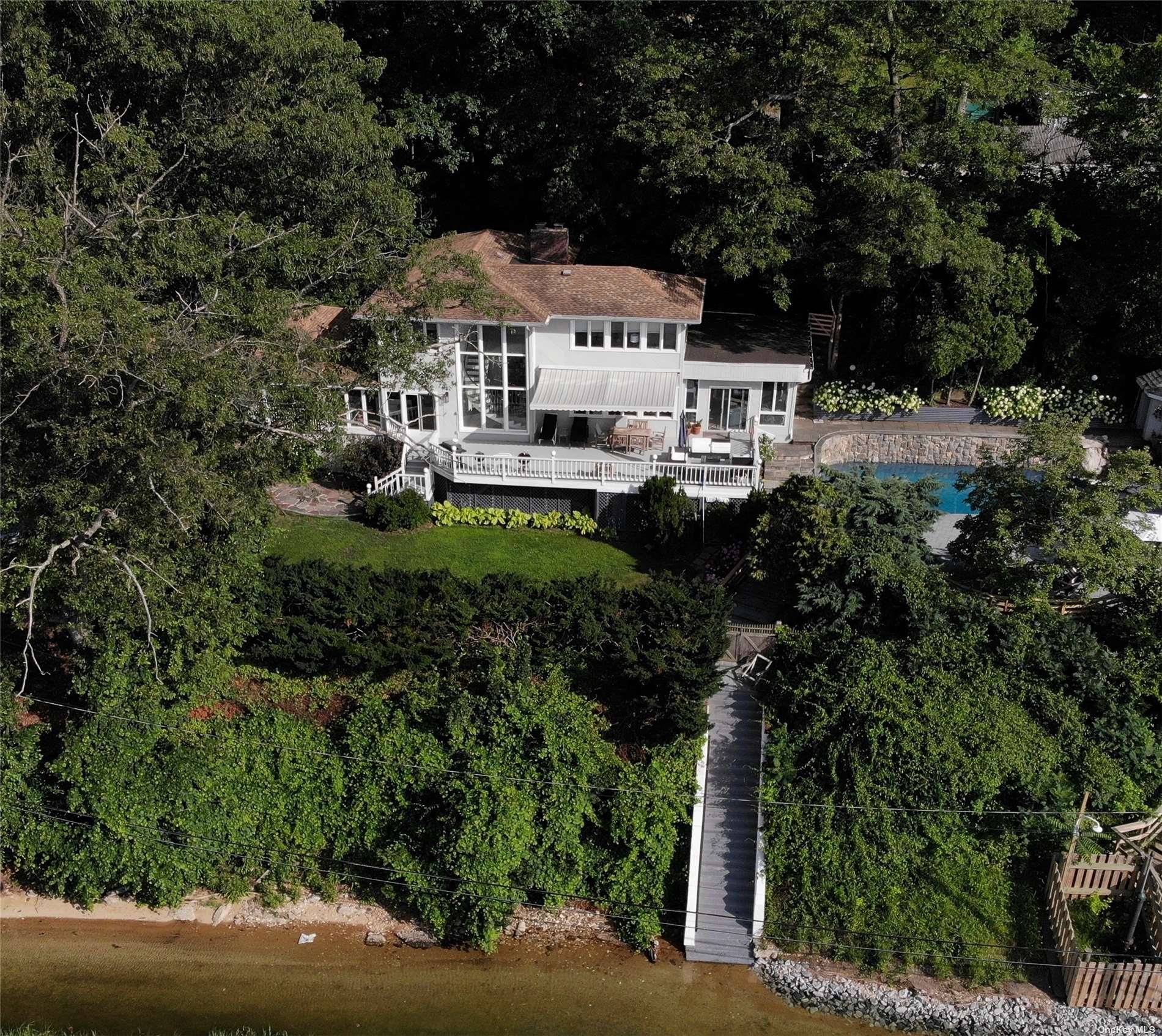 a white house sitting in middle of forest