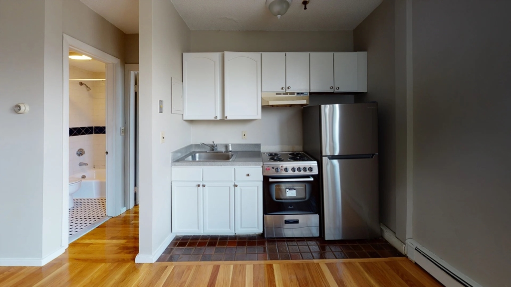 a kitchen with stainless steel appliances a refrigerator and cabinets