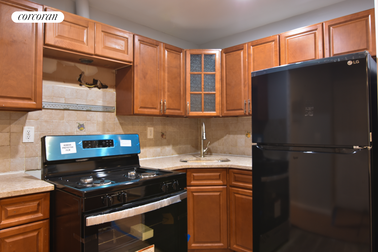 a kitchen with a refrigerator and a stove top oven