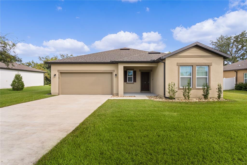 a front view of a house with a yard and garage