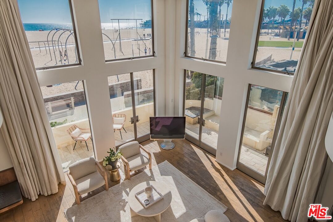 a living room with furniture and a floor to ceiling window