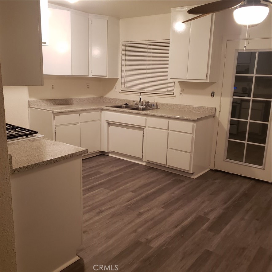 a kitchen with cabinets stove and a sink