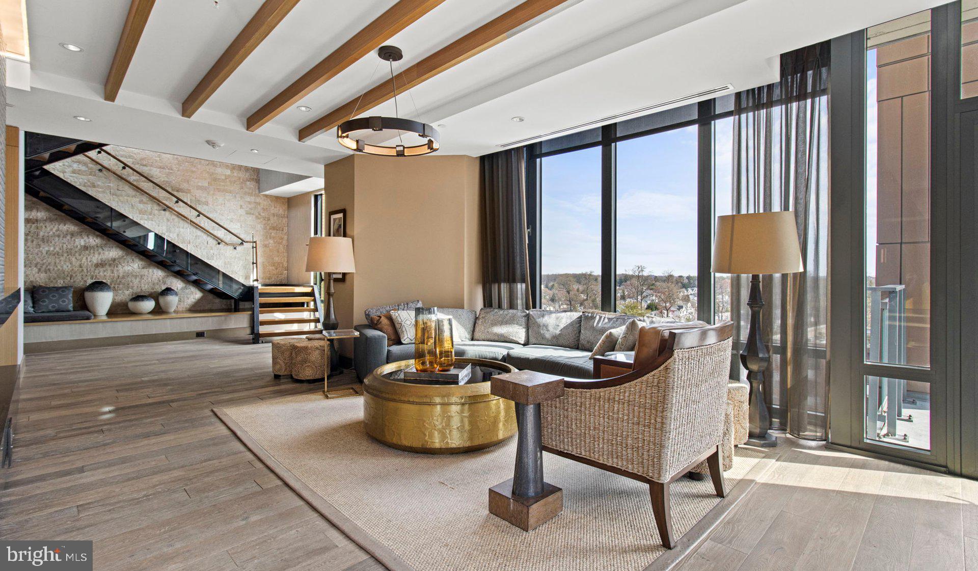 a living room with furniture and a floor to ceiling window