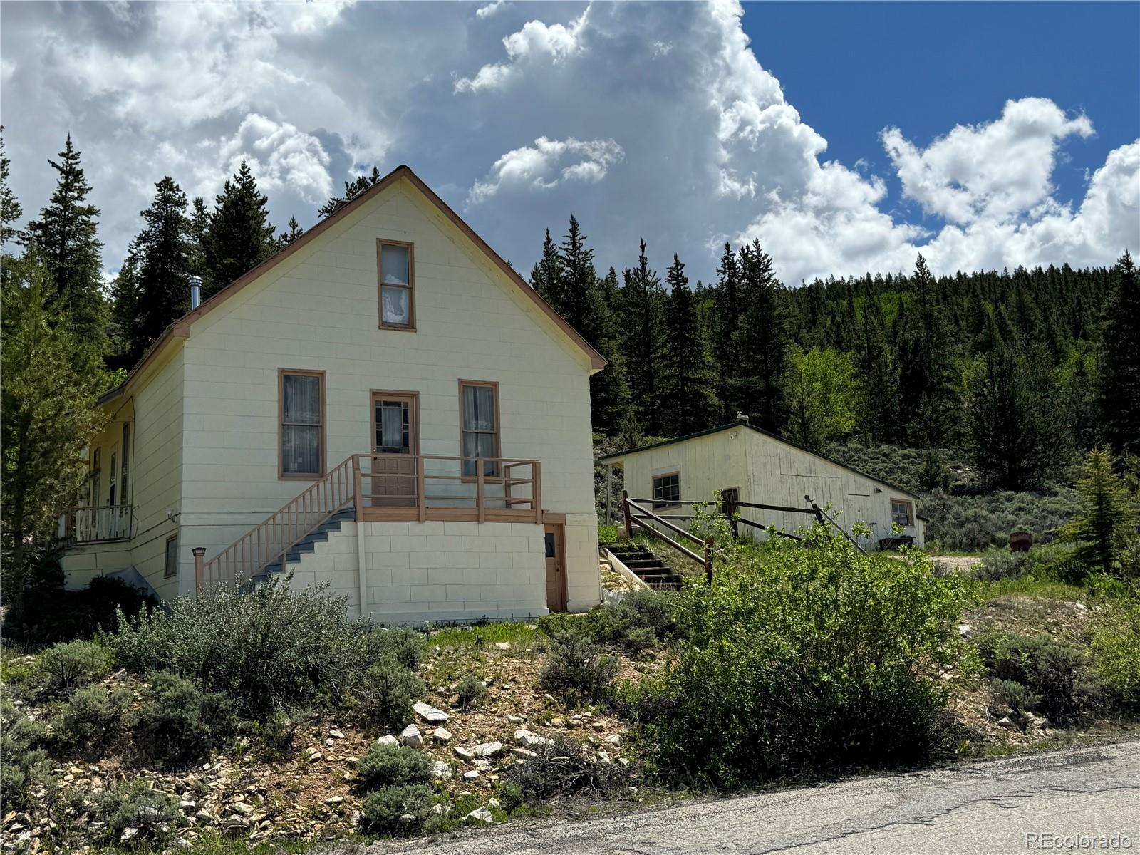 a view of a house with a yard and garden