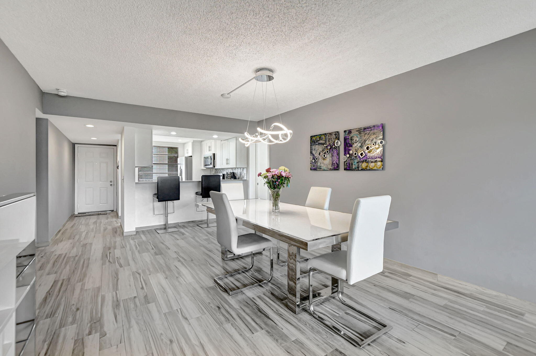 a living room with furniture a dining table and wooden floor