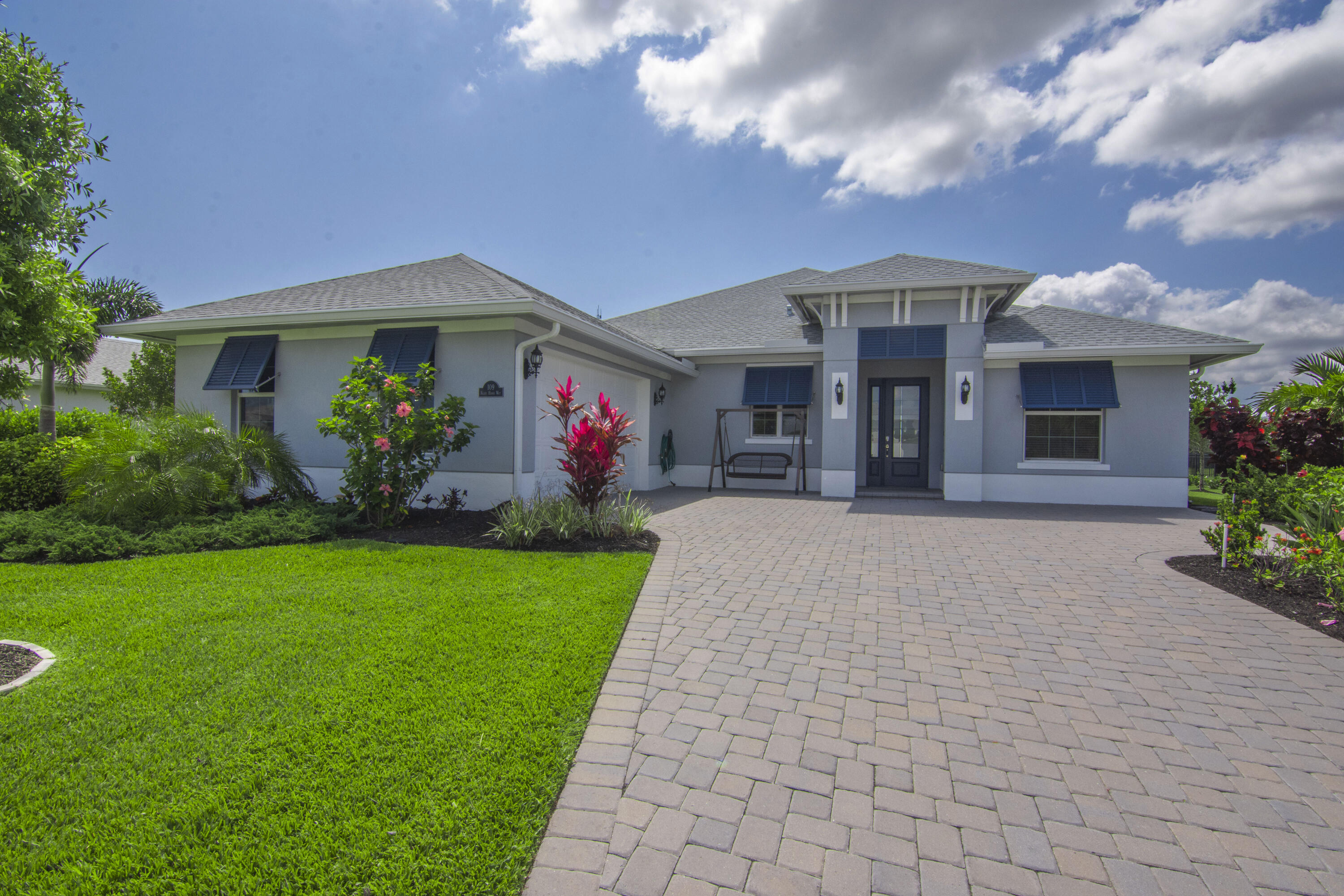 a front view of house with yard and green space