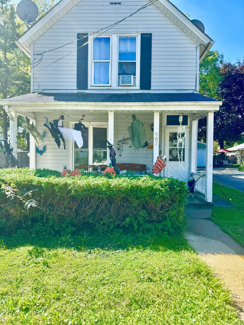 front view of a brick house with a yard