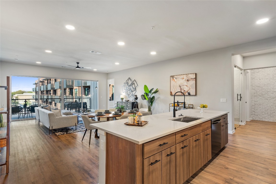 a kitchen with a sink and living room