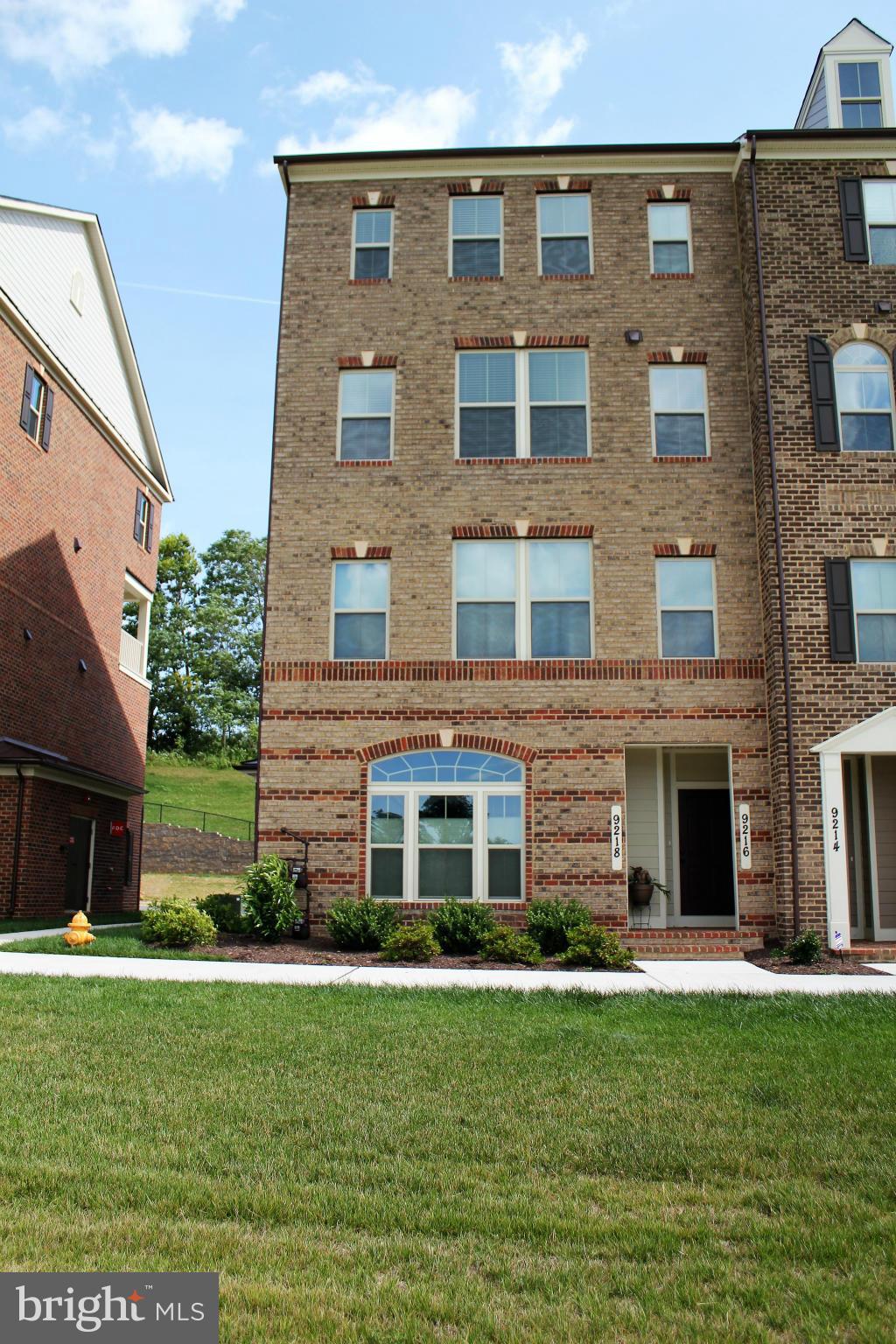 a front view of a building with a garden