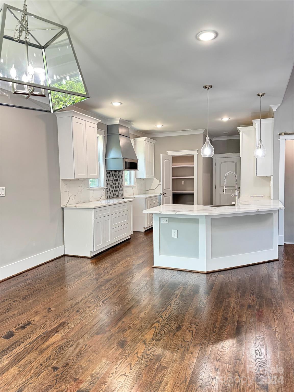 a view of a kitchen with microwave and cabinets