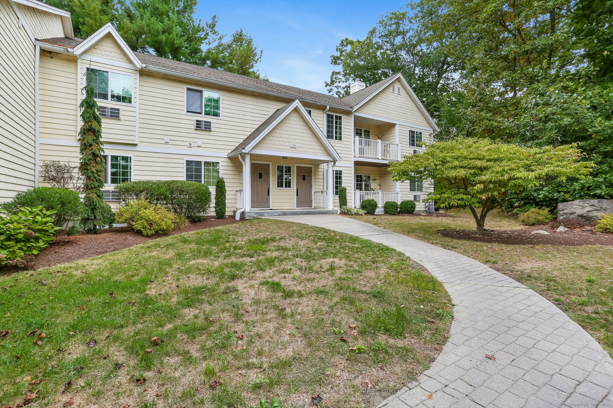 a front view of a house with garden