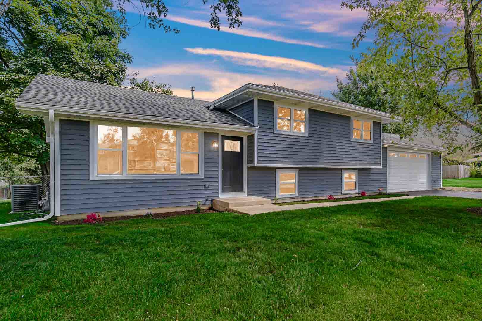 a front view of a house with a yard and garage