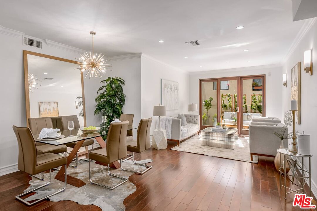 a living room with fireplace furniture and a chandelier