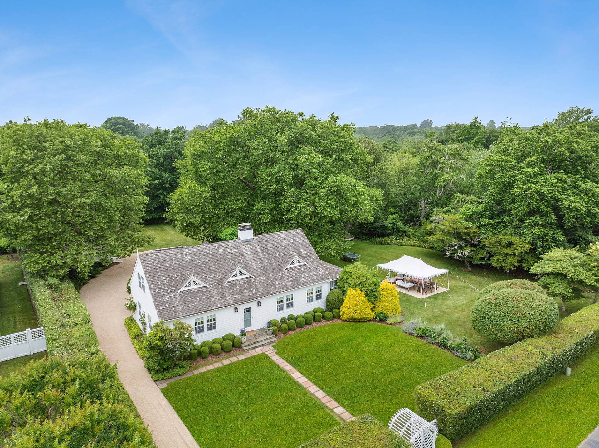 an aerial view of a house with yard and outdoor seating