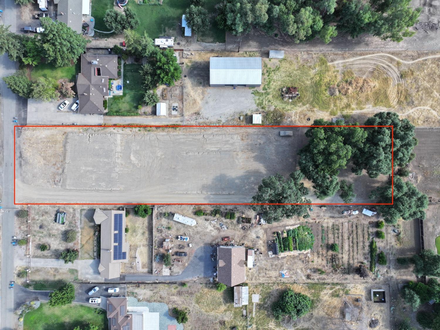 an aerial view of a house with a yard and garden