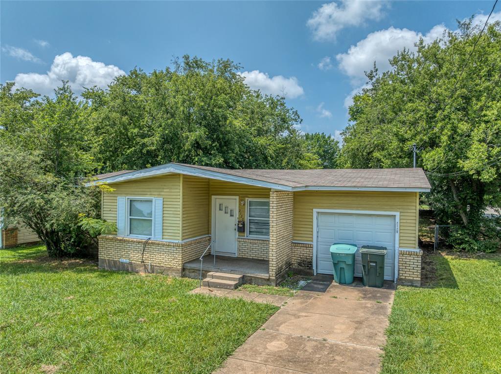 a front view of house with yard and green space