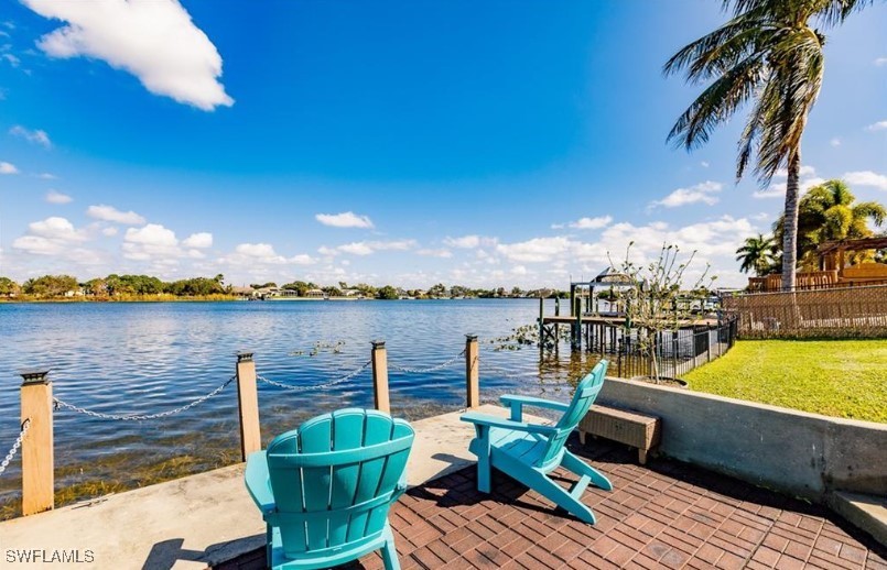 a view of a lake with couches chairs