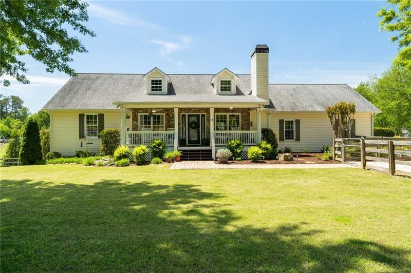 a front view of a house with swimming pool having outdoor seating