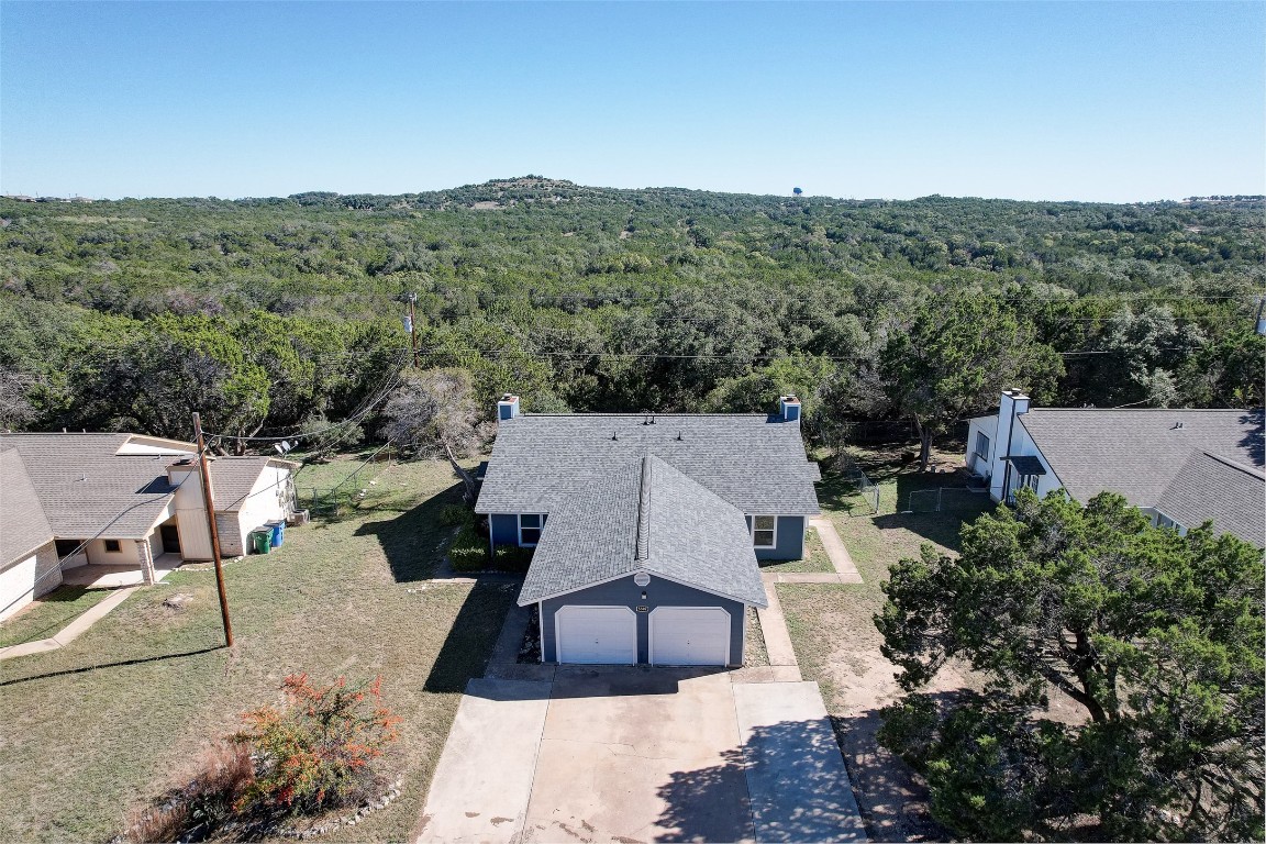 an aerial view of a house with a yard