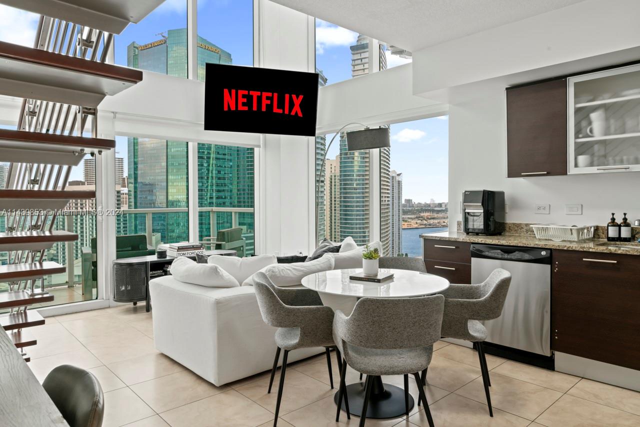 a large kitchen with a table and chairs