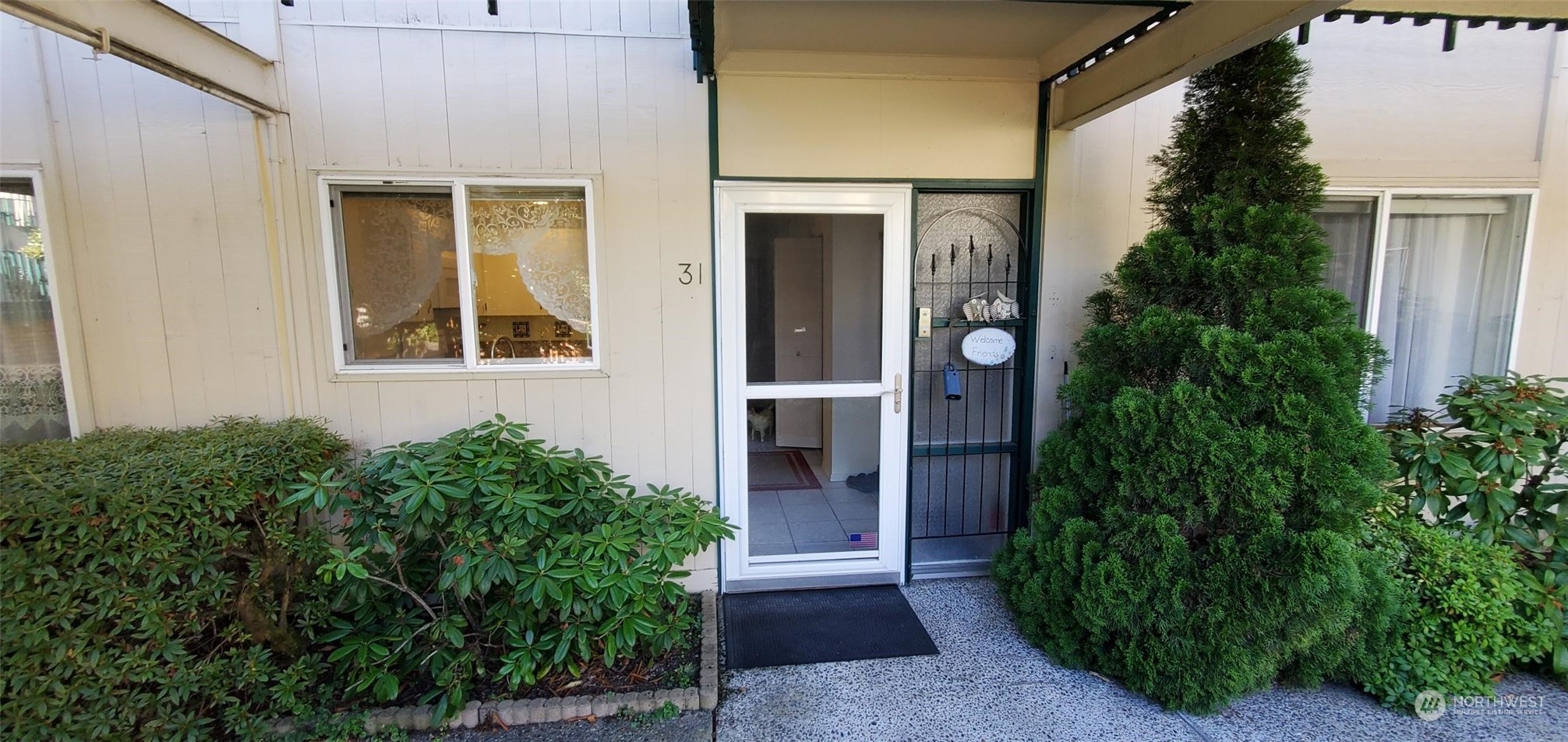 a front view of a house with a garden