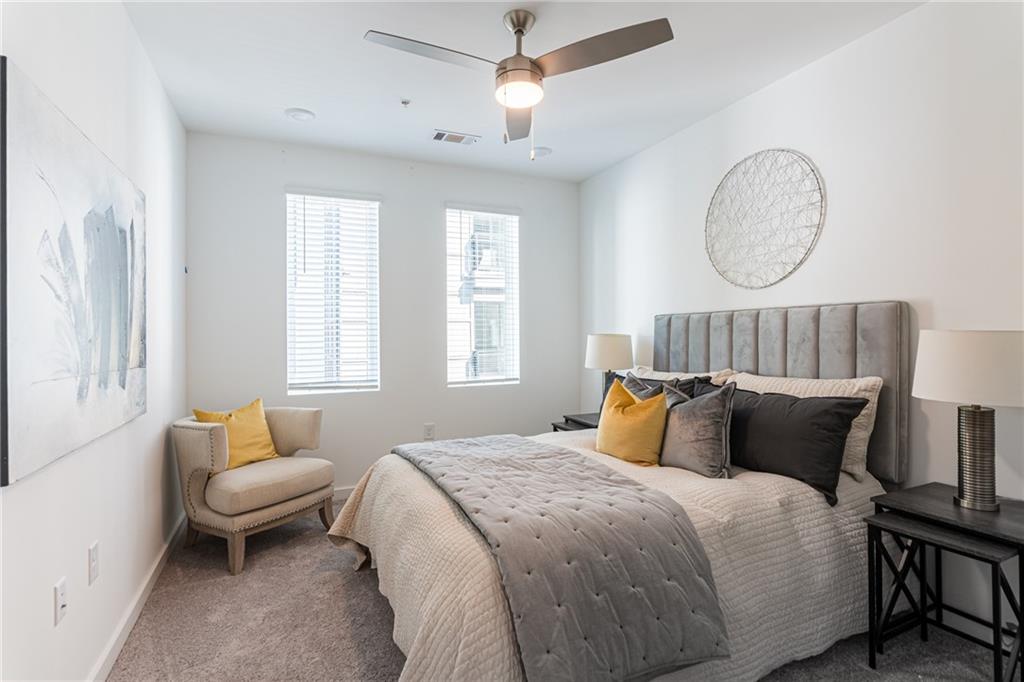 a bedroom with bed and a chandelier