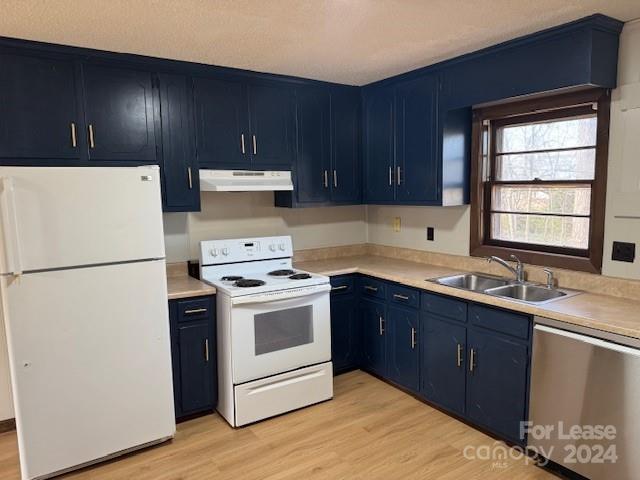 a kitchen with a white stove top oven and refrigerator