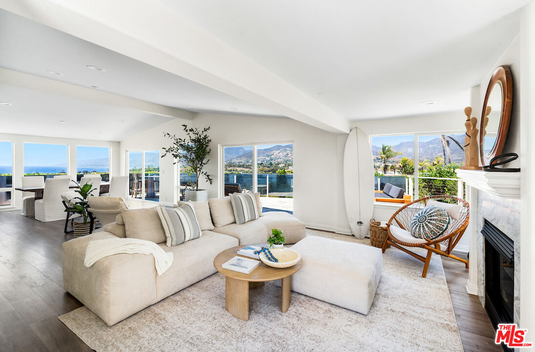 a living room with furniture a fireplace and a flat screen tv