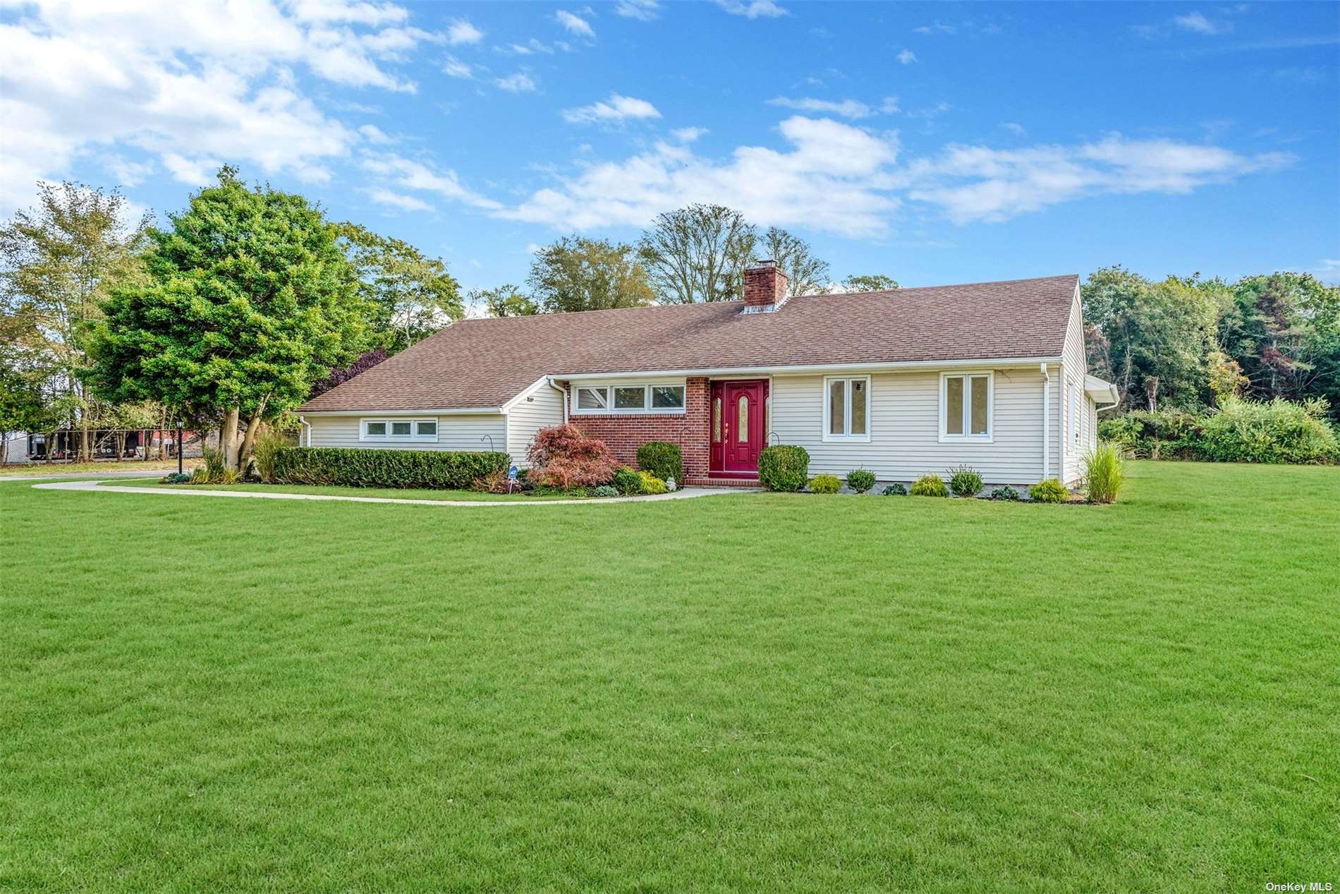 a front view of house with yard and green space