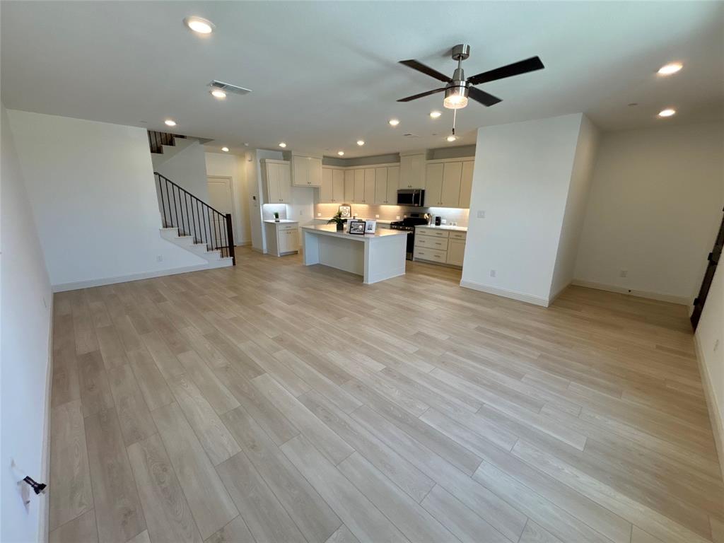 a view of kitchen with cabinets and wooden floor