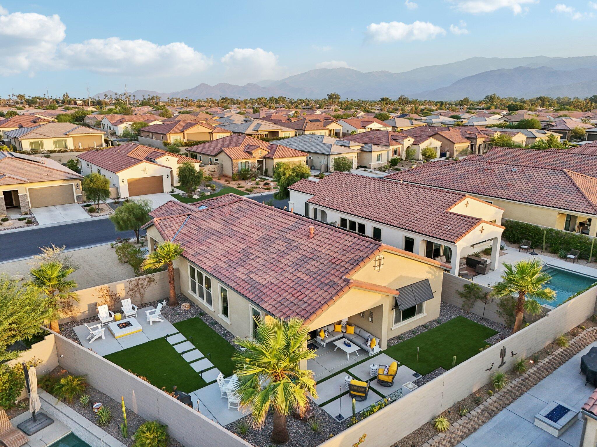 an aerial view of multiple houses with a yard