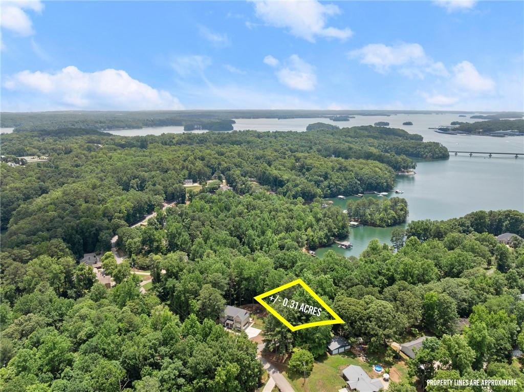 an aerial view of a house with a yard and lake view