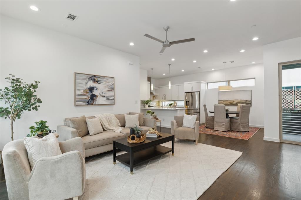 a living room with furniture and a view of kitchen